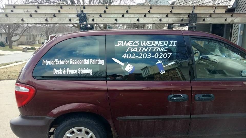Maroon minivan with James Werner II Painting window decals advertising interior/exterior residential painting and deck/fence staining services with phone number 402-203-0207
